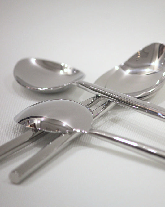 Set of silver spoons on a white background