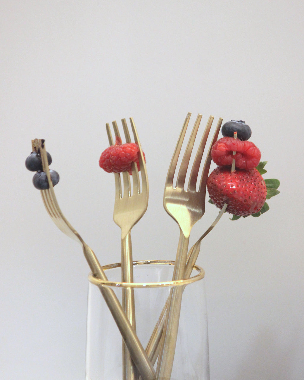 Gold forks with berries 