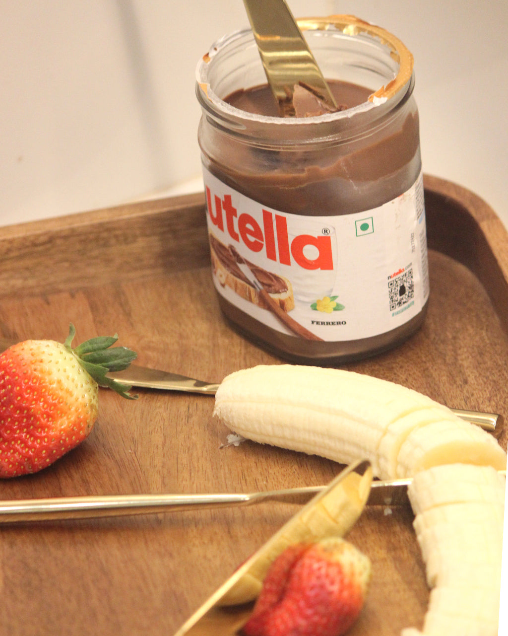 Cutted by chillilemon knife Jar of Nutella with a spoon, banana, and strawberries ,